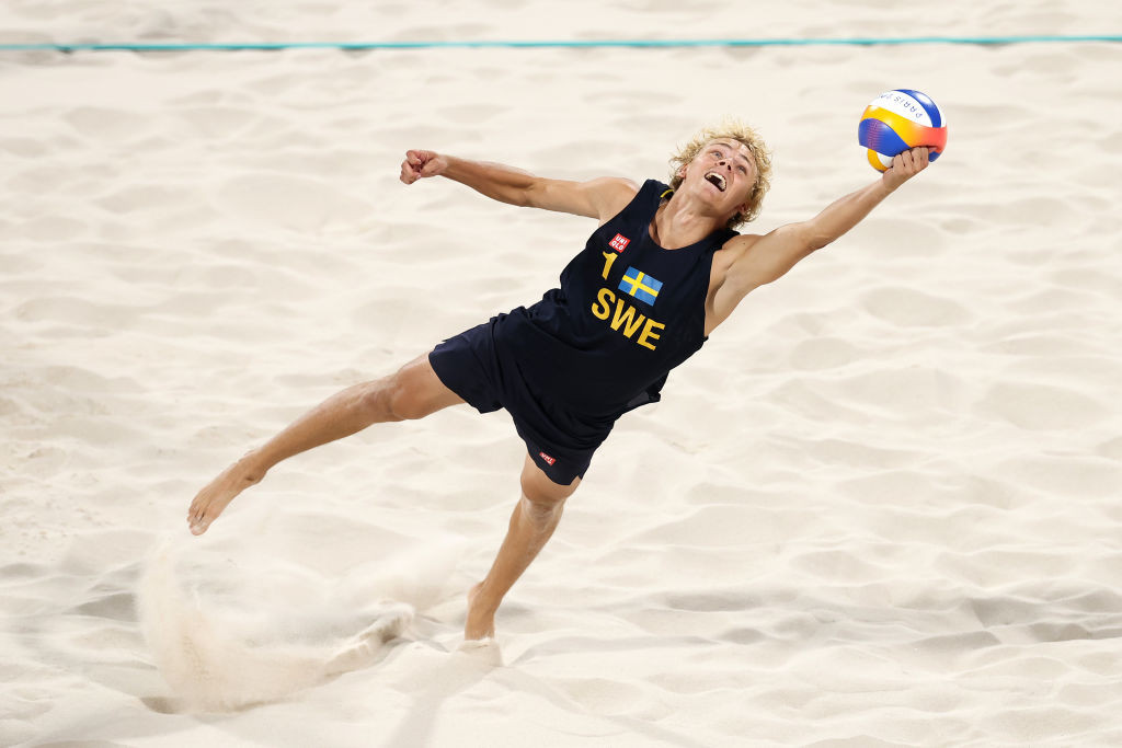 David Ahman of Team Sweden dives for the ball during the Men's Gold Medal match against Nils Ehlers and Clemens Wickler of Team Germany  GettyImages