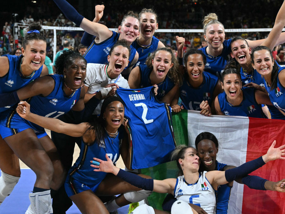 Italy ecstatically celebrates their first medal in volleyball—a triumphant gold. GETTY IMAGES