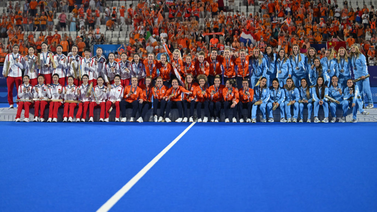 China, Netherlands and Argentina pose on the podium after the women's final field hockey. GETTY IMAGES