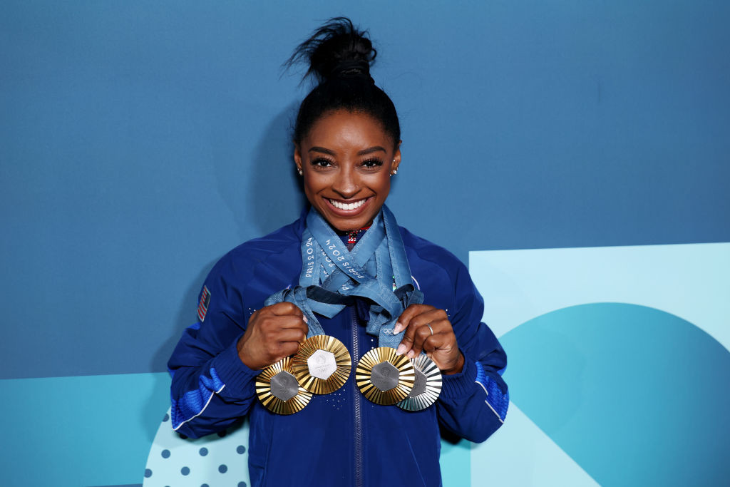 Simone Biles poses with her Olympic medals. GETTY IMAGES