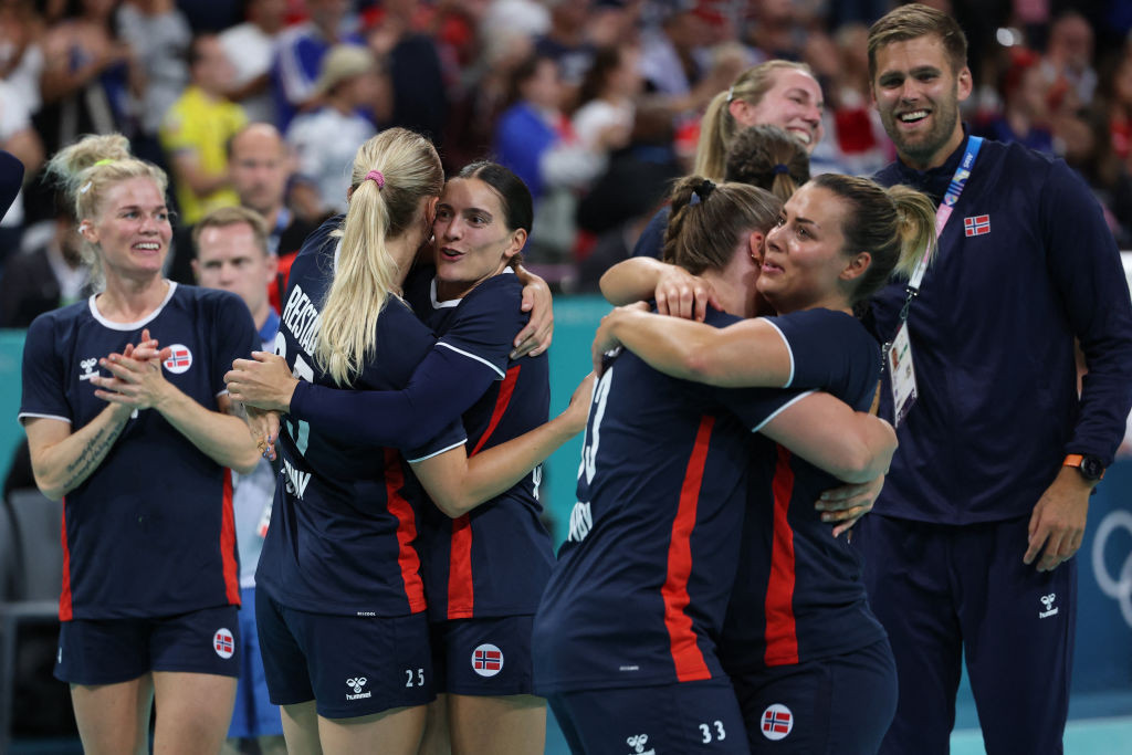 Norways left back 04 veronica kristiansen l norways right back 09 nora mork front r and teammates celebrate their victory. GETTY IMAGES