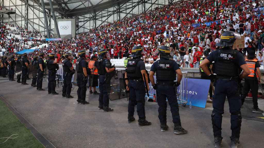 Police members tsand in line before a grandstand during the men's semi-final football match . GETTY IMAGES