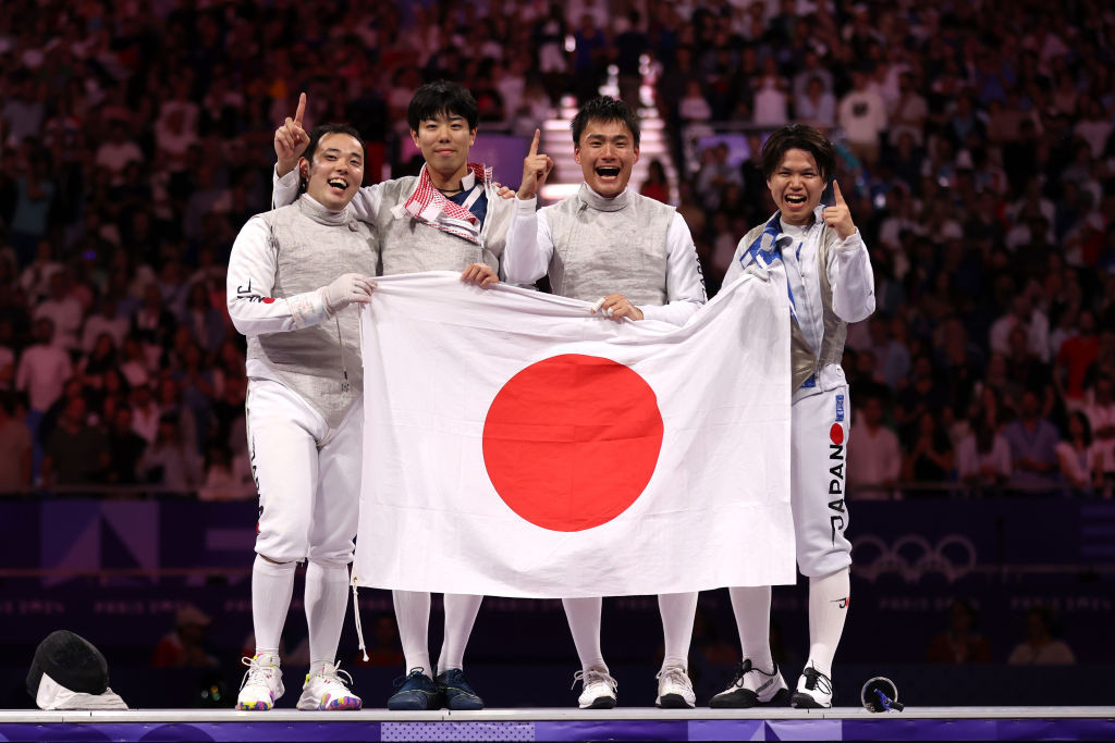 Yudai Nagano, Takahiro Shikine, Kyosuke Matsuyama and Kazuki Iimura of Team Japan celebrate victory against Team Italy during the Fencing Men's Foil Team Gold Medal GettyImages