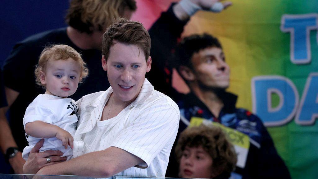 Dustin Lance Black, husband of Tom Daley, and their child are seen in attendance as they show their support during the Men’s Synchronised 10m Platform Final. GETTY IMAGES