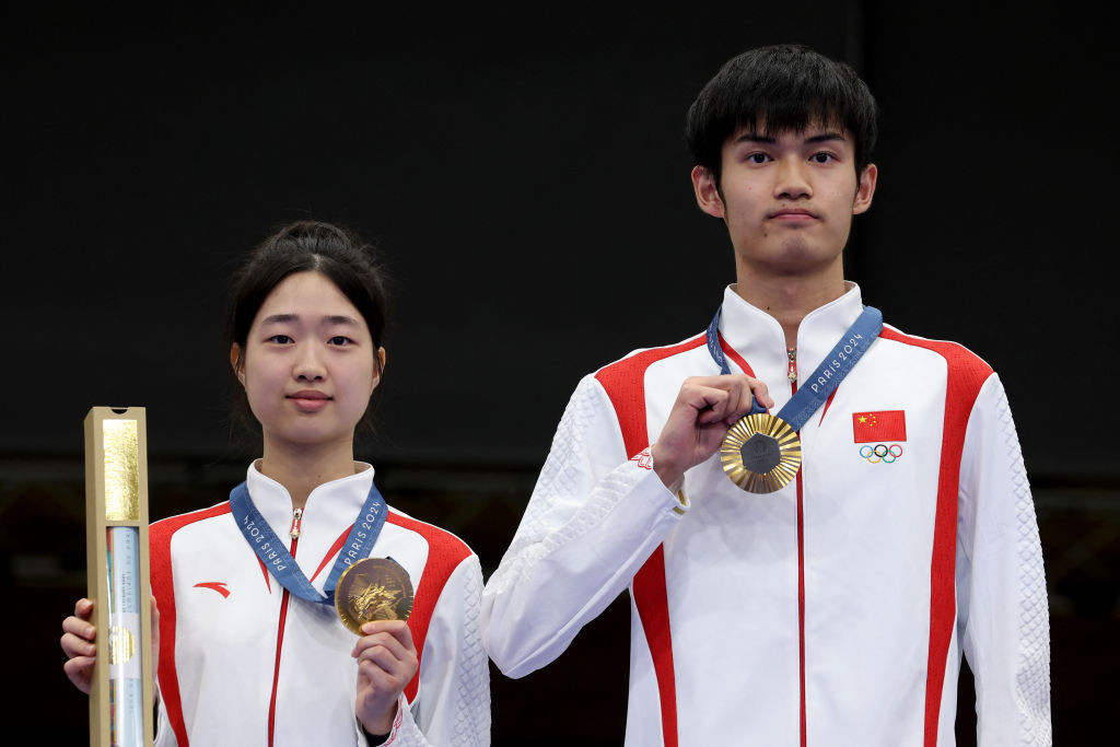 Sharp-shooting teens Huang Yuting and Sheng Lihao took mixed team air rifle gold for China. GETTY IMAGES