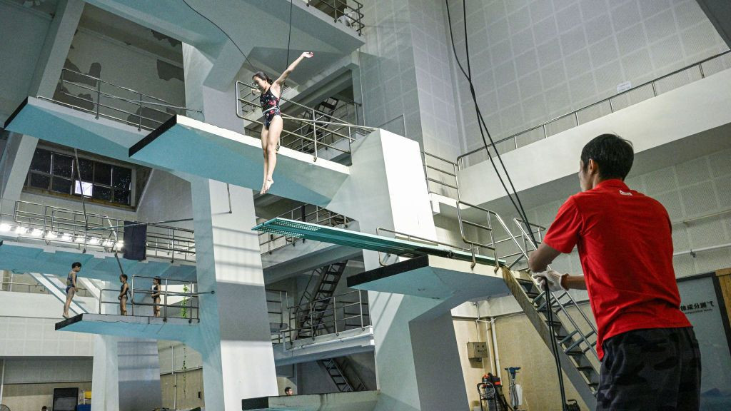 Young diverpracticing into a pool at Muxiyuan sport school in Beijing. GETTY IMAGES