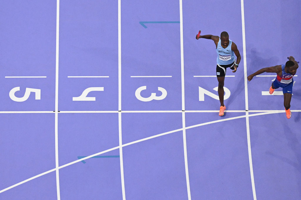 Letsile Tebogo and US' Rai Benjamin crossing the finish line. GETTY IMAGES