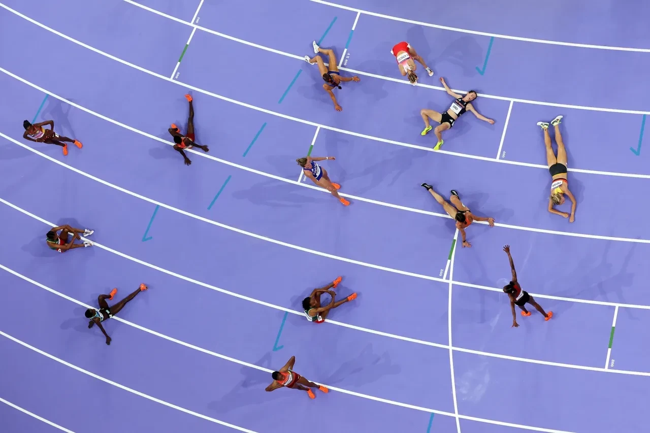 Athletes are seen exhausted after the 3000m steeplechase final. RICHARD HEATHCOTE/GETTY IMAGES