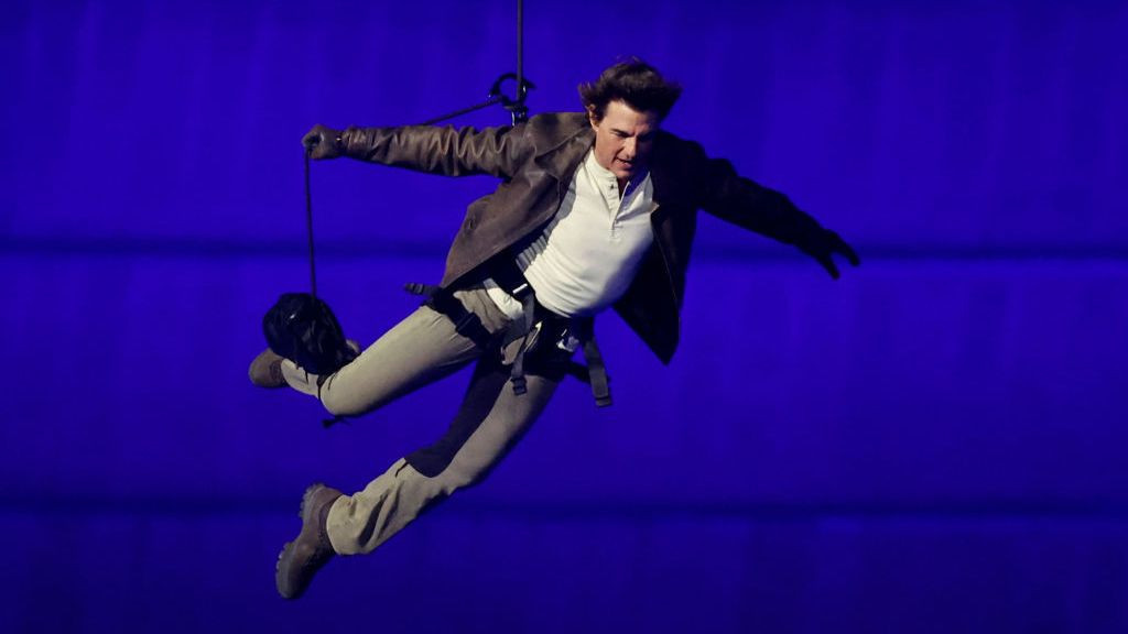 Actor Tom Cruise jumps from the roof of the Stade de France during the Closing Ceremony. GETTY IMAGES