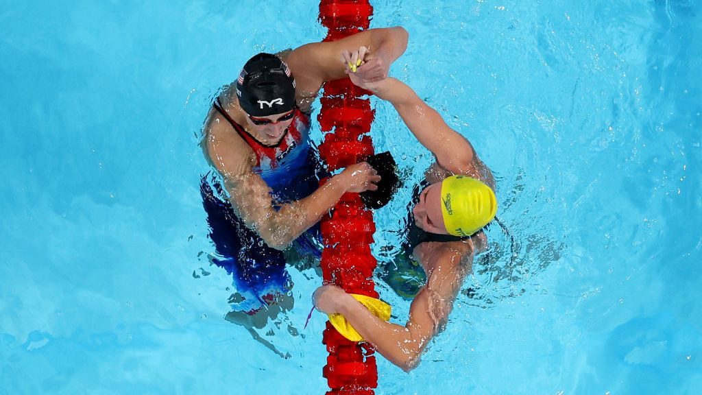 Katie Ledecky of Team United States and Ariarne Titmus of Team Australia celebrate after winning gold and silver in the Women's 800m Freestyle Final. GETTY IMAGES