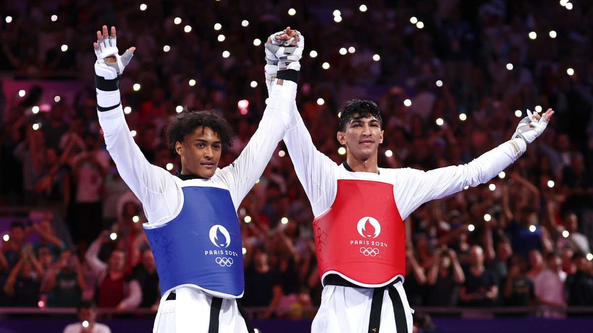 Caden Cunningham (blue) of Great Britain and Arian Salimi of Iran after their final fight. GETTY IMAGES