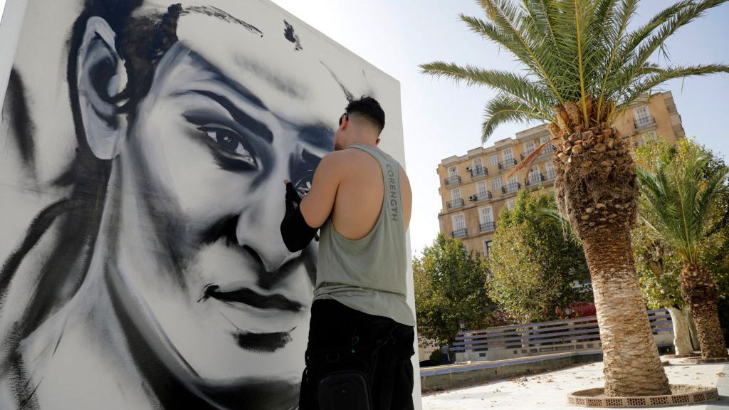 An artist paints a large portrait of Algerian boxer Imane Khelif in Tiaret. GETTY IMAGES