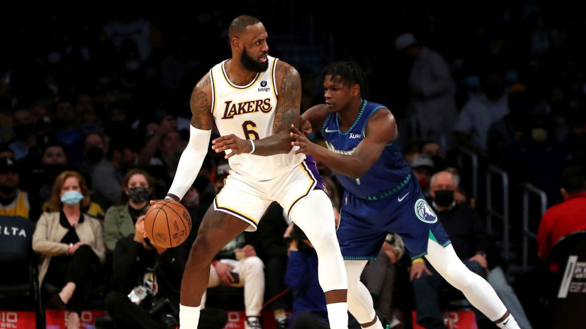 LeBron James with the ball being defended in the post by Anthony Edwards. GETTY IMAGES