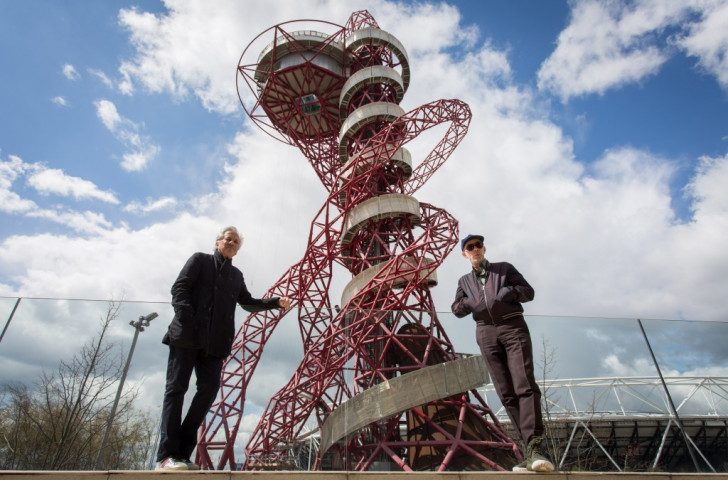 Designers Anish Kapoor (left) and Carsten Holler pictured last month in front of the ArcelorMittal Orbit, with the slide which will officially open on June 24 now wrapped around it ©Getty Images