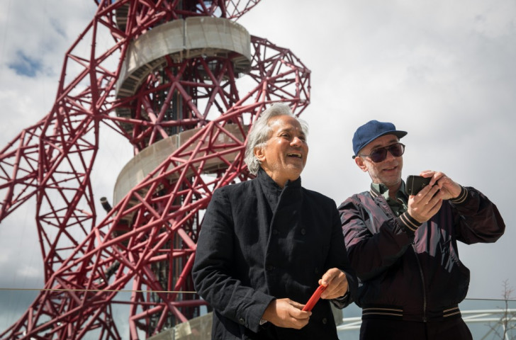 Anish Kapoor (left) and Carsten Holler in front of the ArcelorMittel Orbit which they jointly designed, and which now has the 