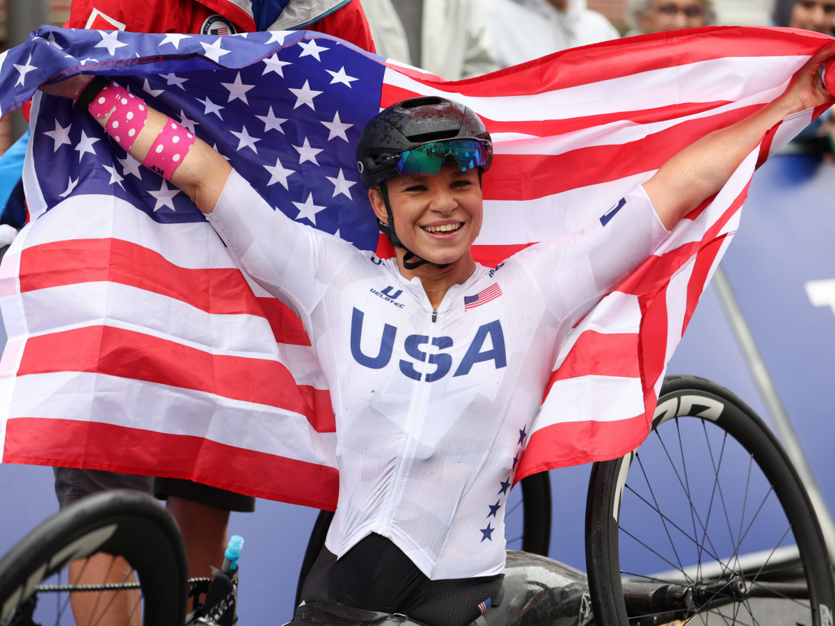 Oksana Masters celebrates with the United States national flag after winning the Women's H5 Road Race at  Paris 2024 Paralympic Games. GETTY IMAGES