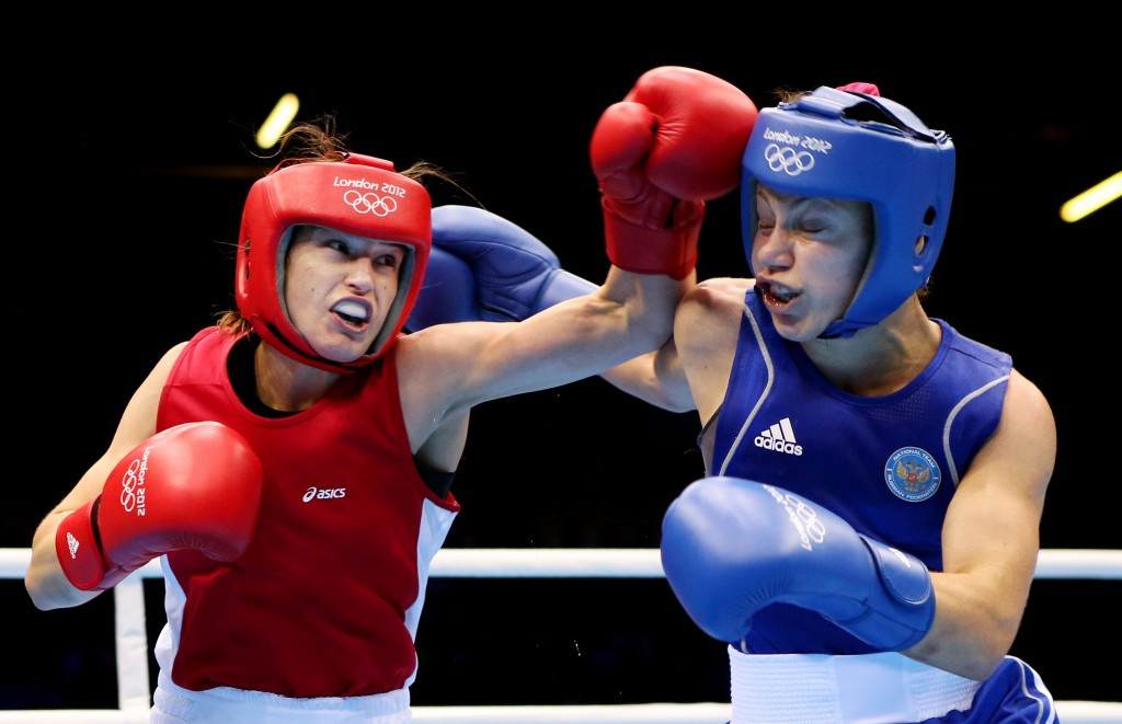 Irish lightweight Katie Taylor, in red, is one of three reigning women's Olympic boxing champions