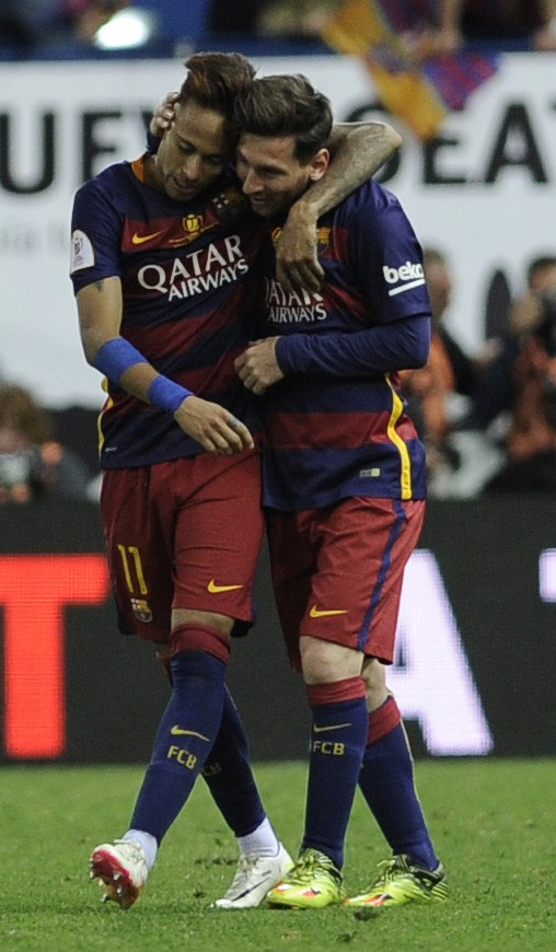 Neymar (left), and Lionel Messi, pictured celebrating Barcelona's 2-0 win over Sevilla on Sunday in Spain's Copa del Rey final, have differing patriotic agendas to attend to this summer