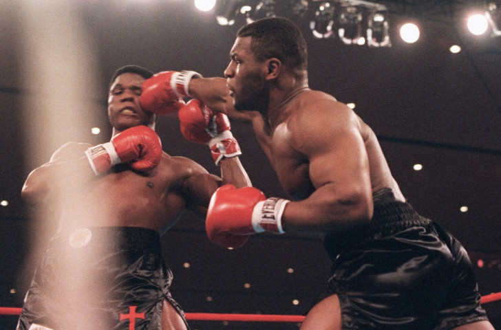 Trevor Berbick, pictured (left) losing his world heavyweight title to Mike Tyson in 1986, received a five-year sentence for sexual assault in 1992 V
