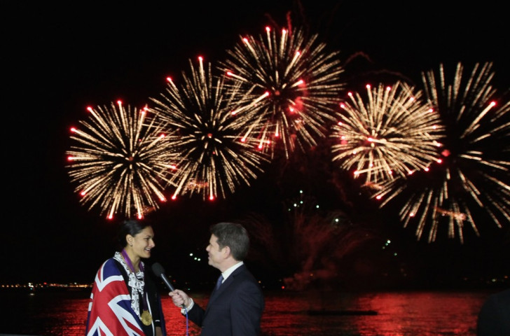 Valerie Adams is interviewed after her medal ceremony at Auckland Harbour in 2012 as fireworks go off in the background to mark her feat  ©Getty Images