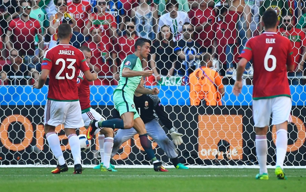 Cristiano Ronaldo scored twice to help Portugal reach the last 16 after a thrilling draw with Hungary