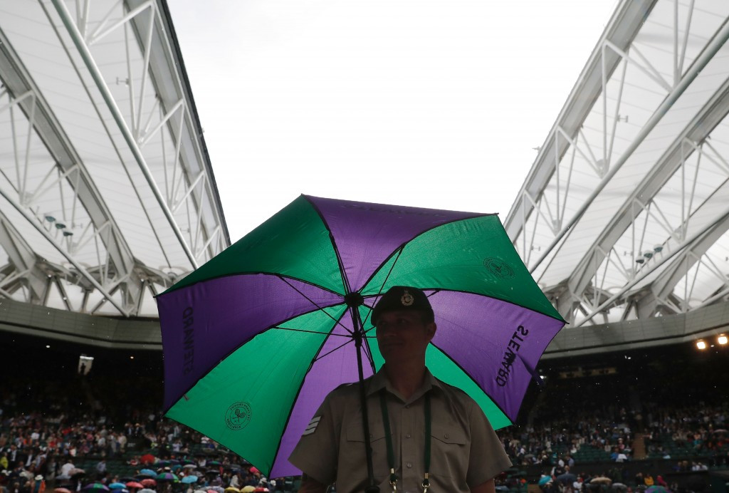 Distinctive Wimbledon umbrellas proved useful again ©Getty Images
