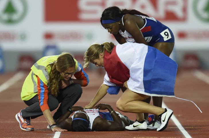 Touch of a champion - Dafne Schippers, winner of the European 100m title, checks on injured training partner Desiree Henry, along with Britain's Asha Philip, before starting her lap of honour ©Getty Images