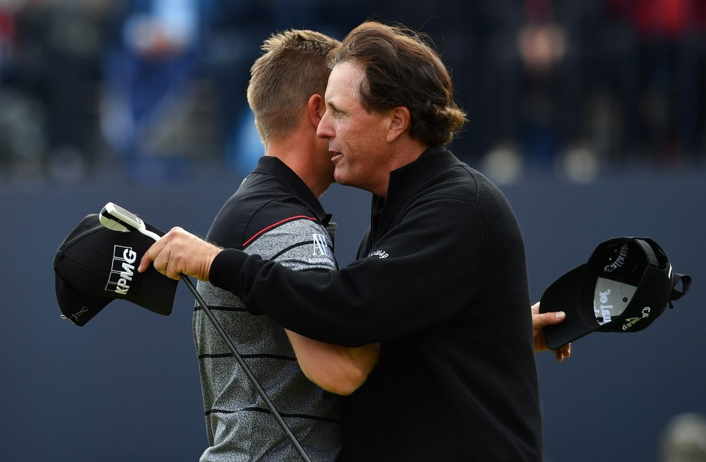 The winner is congratulated by Phil Mickelson (right) following his final round ©Getty Images