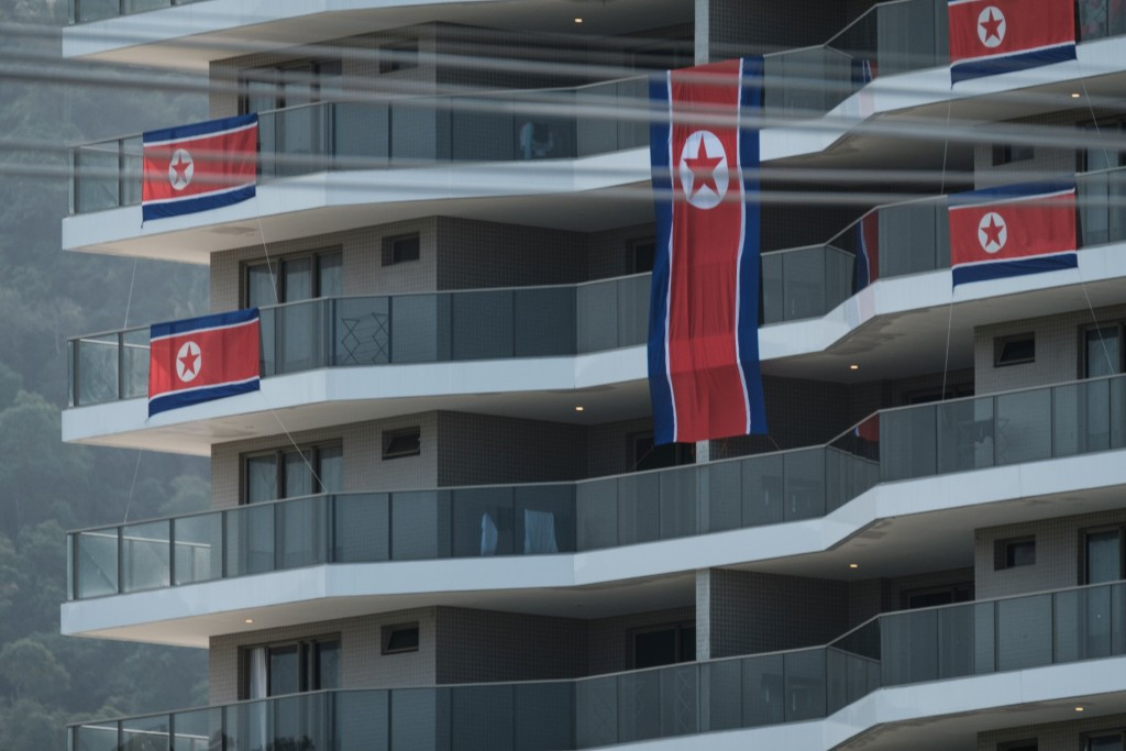 North Korean flags are put onto balconies in the Athletes' Village ©Getty Images