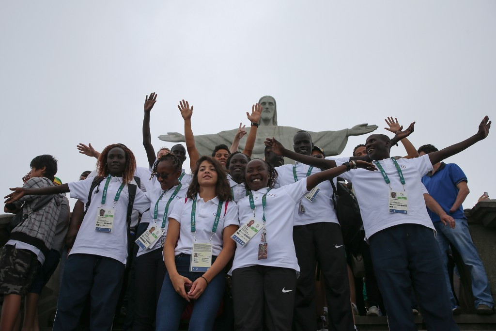 Members of the Refugee Olympic Team pose for a photo in front of the Christ the Redeemer statue ©Getty Images