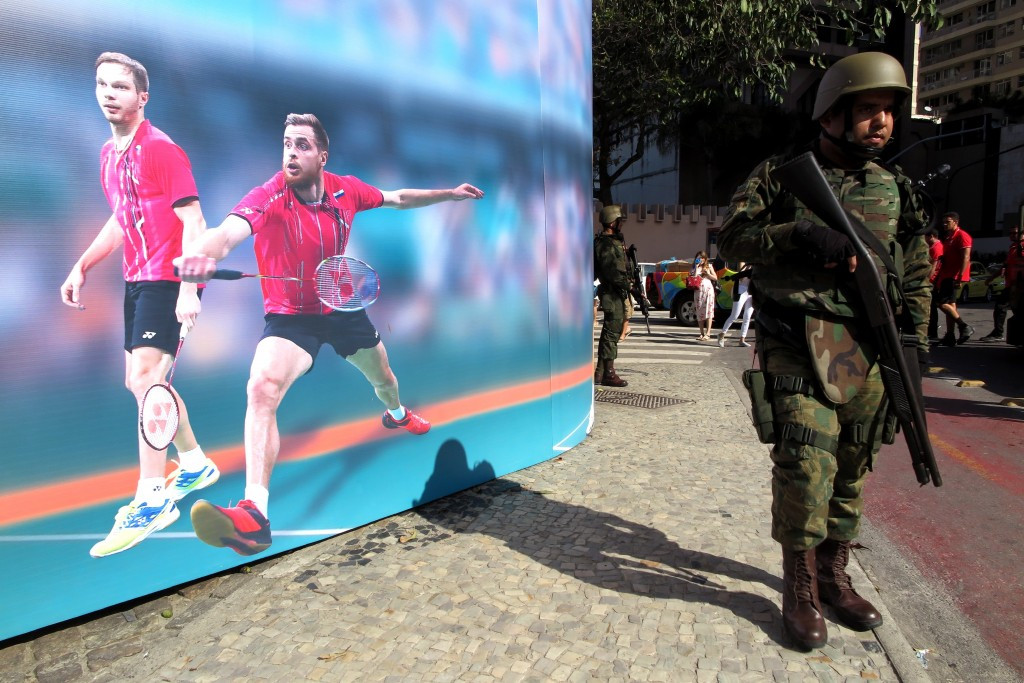 Soldiers patrol past a poster promoting at the Olympics on Rio de Janerio's iconic Copacabana Beach ©Getty Images