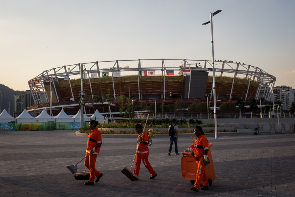 Workmen in the Olympic Park wait for the arrival of the thousands of spectators ©Getty Images