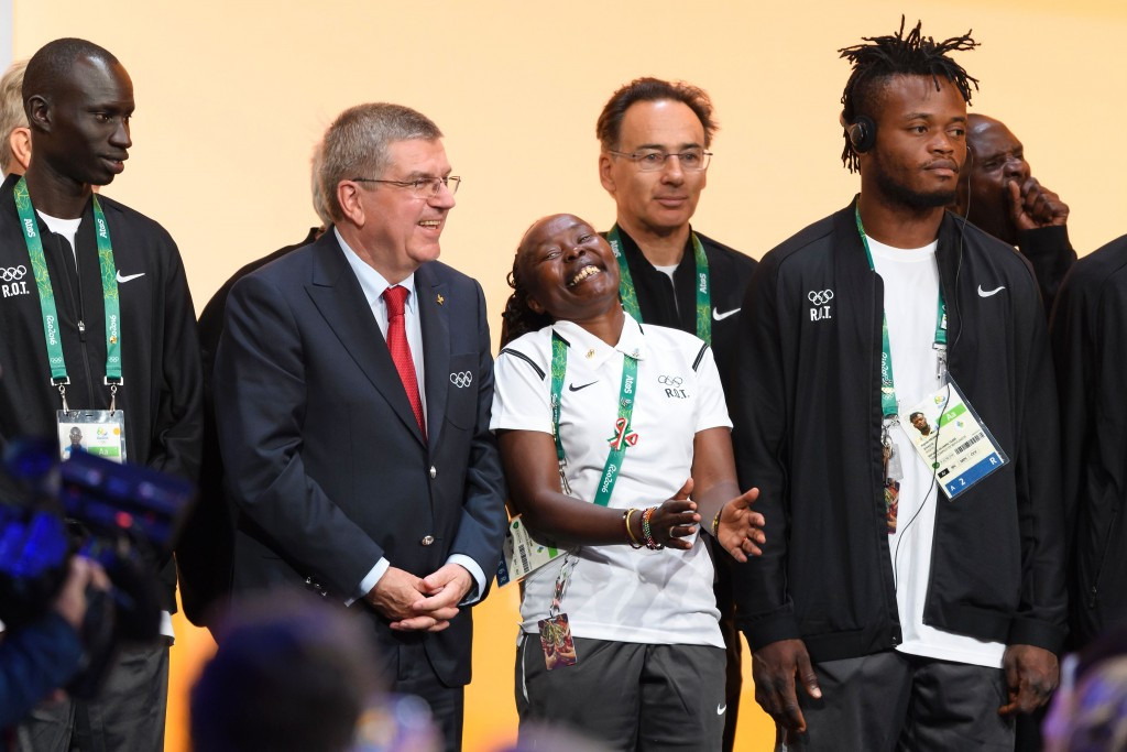 IOC President Thomas Bach surrounded by refugee athletes at Rio 2016 ©Getty Images