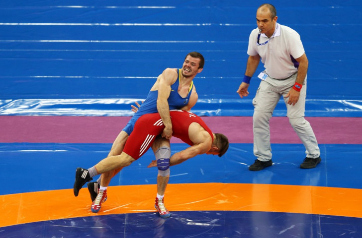 Slovakia's Istvan Levai (red) and Ukraine's Denys Dem'Yankov (blue) compete in a men's wrestling 66kg Greco-Roman bronze medal match at the Heydar Aliyev Arena ©Getty Images 