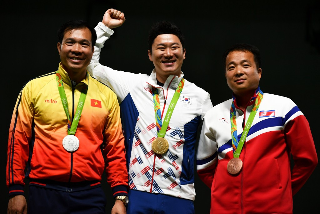 It was an all Asian medal podium in the 50 metre pistol as Vietnam's Hoang Xuan Vinh, left, claimed the silver medal and North Korea’s Kim Song Guk, right, the bronze ©Getty Images