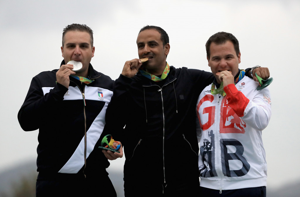 Kuwait's Fehaid Al-Deehani, representing the Independent Olympic Athletes, celebrates his gold medal with Italy's Marco Innocenti, left, and Britain's Steve Scott, right, who won the silver and bronze ©Getty Images