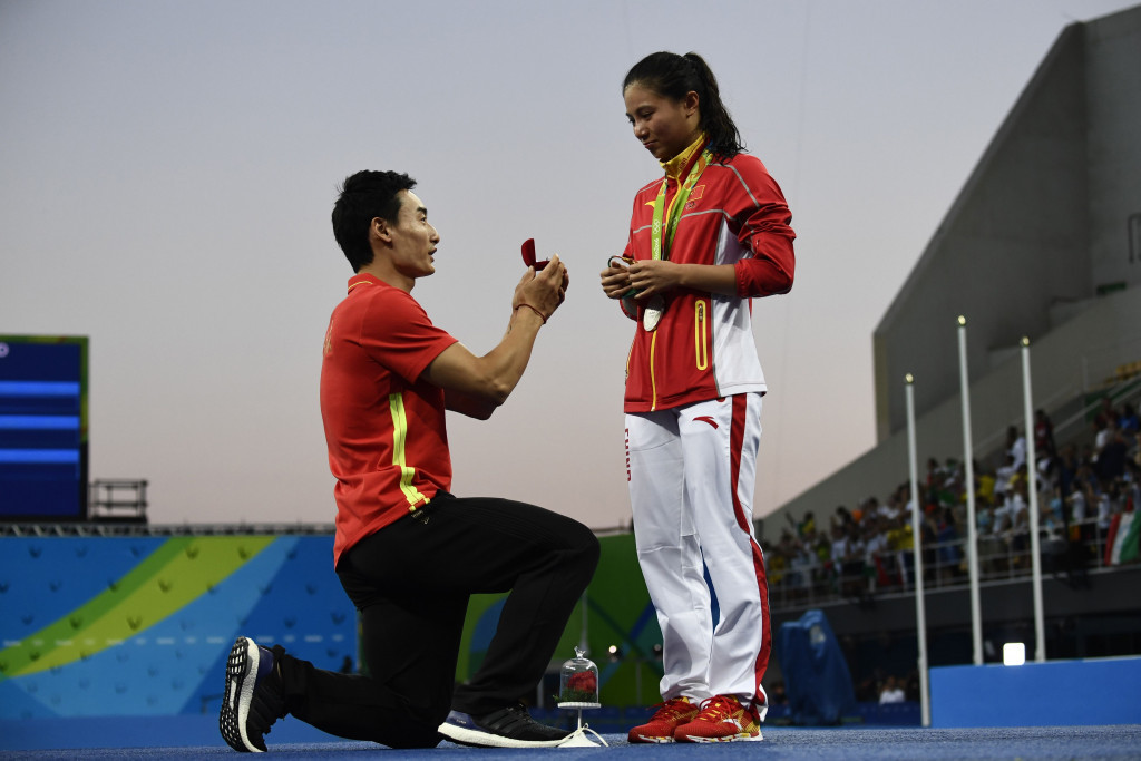 Silver medallist China's He Zi receives a marriage proposal from fellow diver Qin Kai during the podium ceremony of the 3m springboard final ©Getty Images