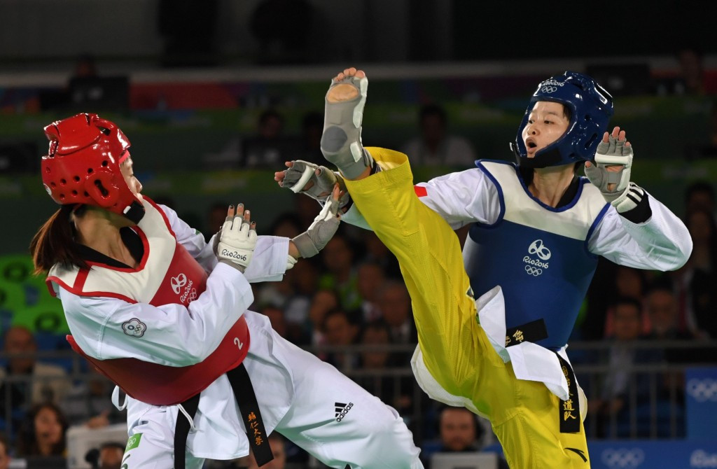 Taekwondo action began with players wearing multi-coloured 