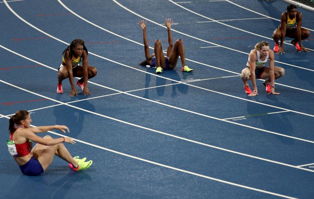 Runners collapse onto the track after the women's 400m hurdles final ©Getty Images