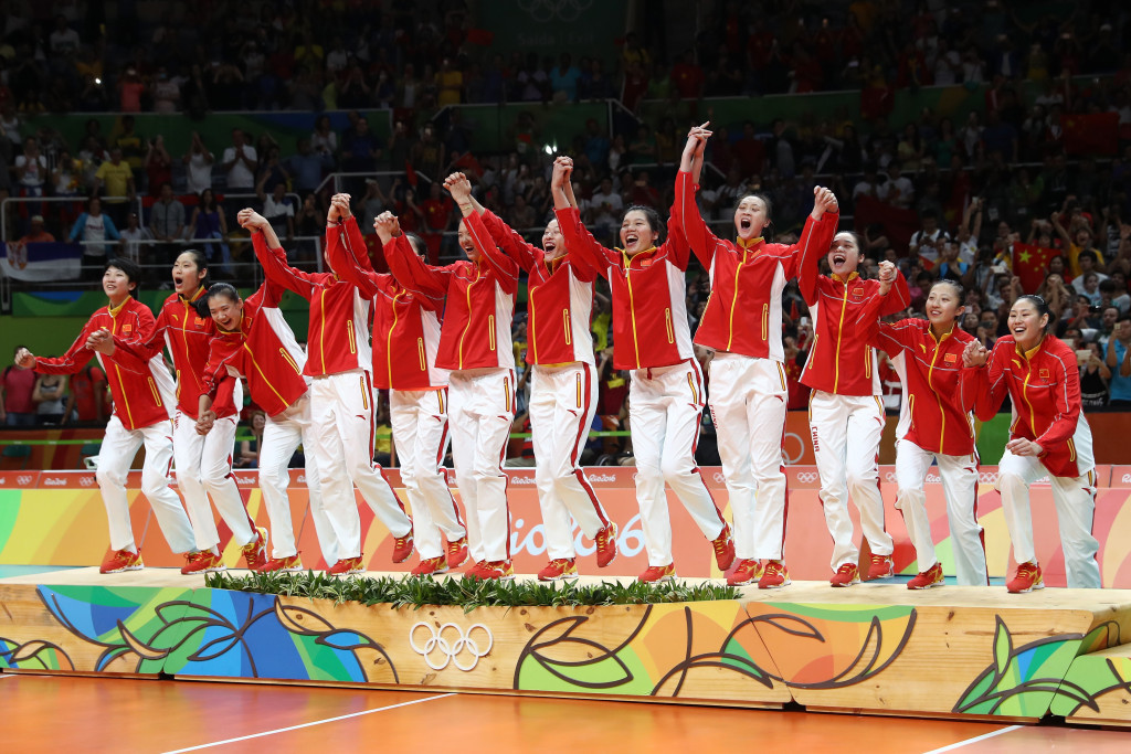 China jump onto the podium in celebration after claiming the women's volleyball gold medal ©Getty Images