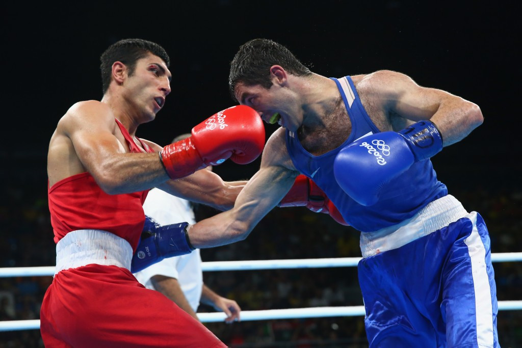 Uzbekistan's Shakhobidin Zoirov (red) upset Russia's Misha Aloian in the men's flyweight gold medal match ©Getty Images