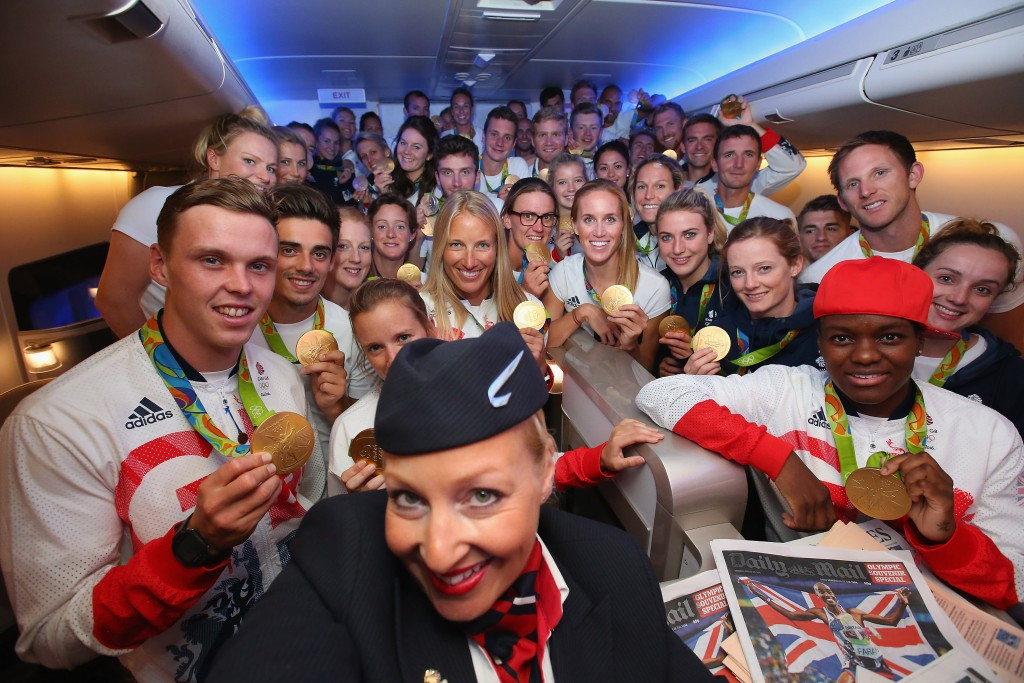 British gold medal winners pose with a lucky member of the British Airways cabin crew before they fly home ©Getty Images