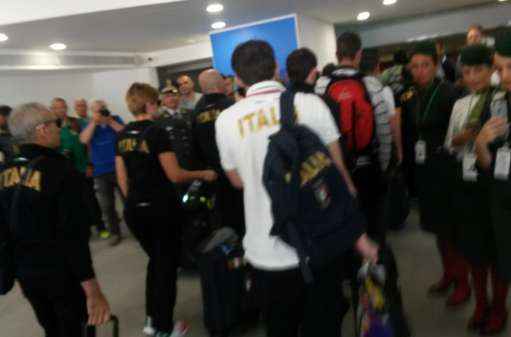 Italy's returning Olympians meet the first wave of photographers at Rome airport before going through to meet the welcoming public ©insidethegames
