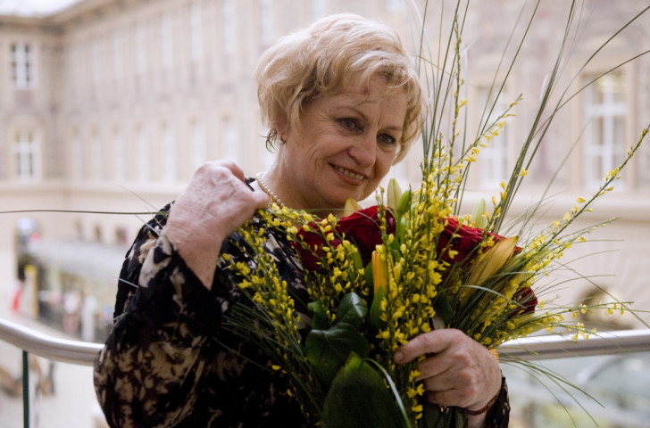 Vera Caslavska holds a bouquet after attending a press conference in Prague in 2012, her 20-year internal exile long over ©Getty Images