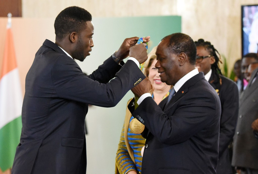Cheick Sallah Cisse (left) was rewarded for his gold by President Alassane Ouattara (right) ©Getty Images