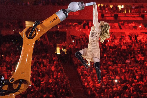 A seductive dance featuring an industrial robot and Paralympic snowboarder Amy Purdy of the United States aimed to highlight human kind's coexistence with technology ©Getty Images