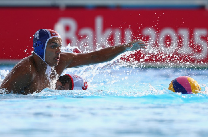Slovakia's Samuel Baran (blue) and Montenegro's Duro Radovic  (white) battle for the ball during a men's water polo match ©Getty Images