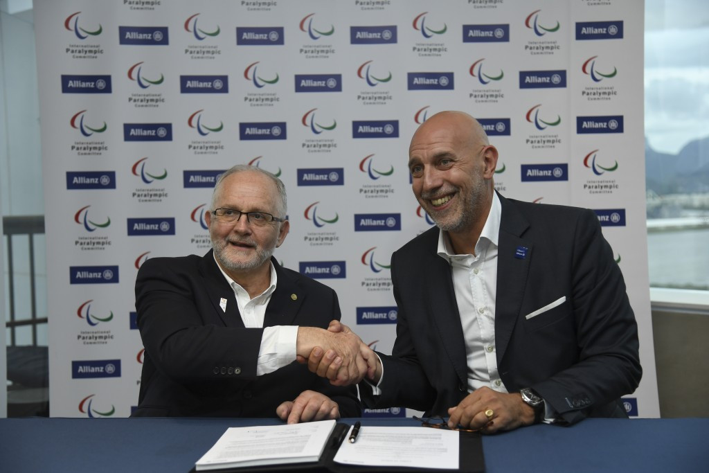 IPC President Sir Philip Craven, left, and Jean-Marc Pailhol, head of Allianz SE's market management and distribution, sign the renewal of the partnership at the Rio 2016 Paralympic Games ©Getty Images