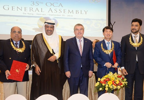 Sheikh Ahmad Al-Fahad Al-Sabah and Thomas Bach presented the three OCA Merit Award winners ©OCA