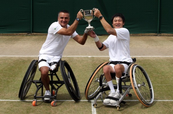 Stephane Houdet of France and Shingo Kunieda of Japan celebrate their Wimbledon doubles title in 2014 ©Getty Images